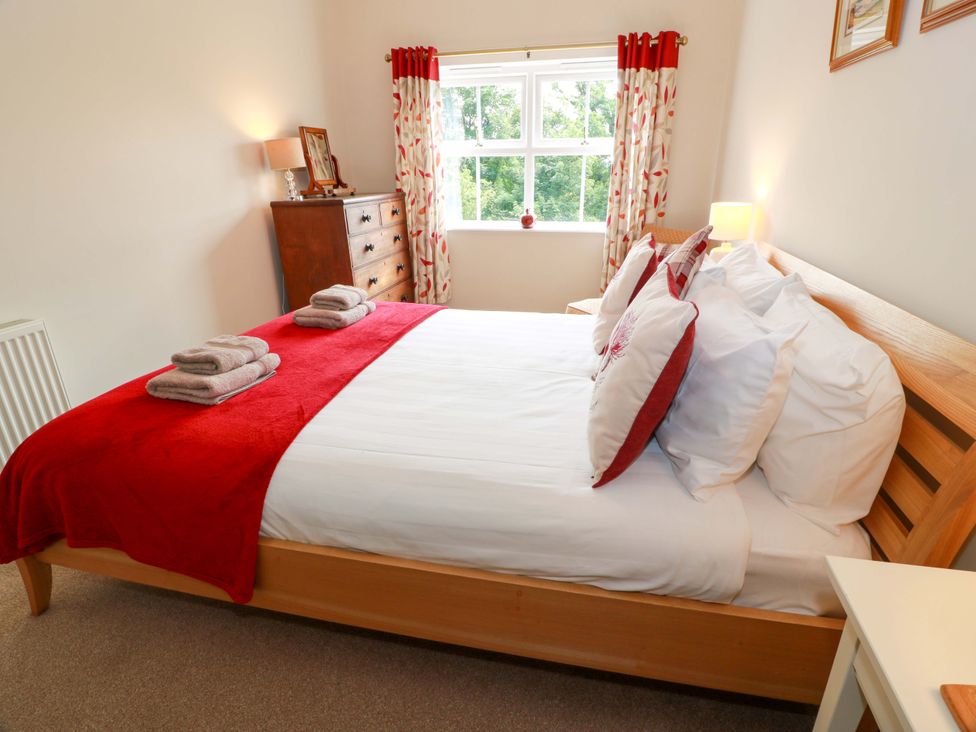 A bedroom with a bed and dresser at Cairnhill in Girvan