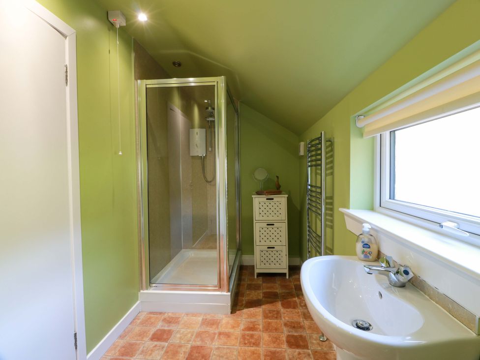 A bathroom featuring a shower and sink at Cairnhill in Girvan