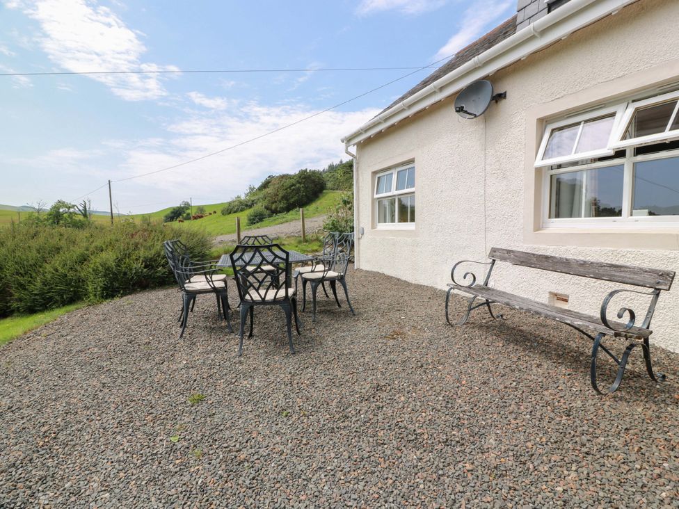 An outdoor seating area with a table and chairs at Cairnhill in Girvan