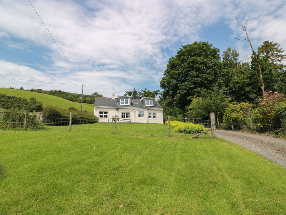 A house with a lawn and trees at Cairnhill in Girvan