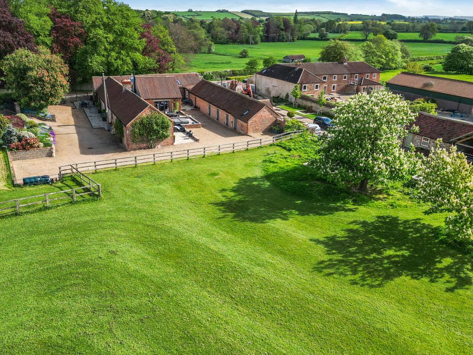 An outdoor view of buildings and fields at Sykes Lodge in Malton
