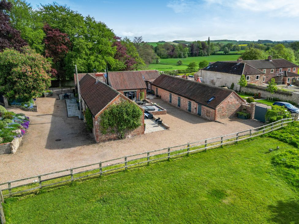 An outdoor view of a house with patio and garden at Sykes Lodge in Malton