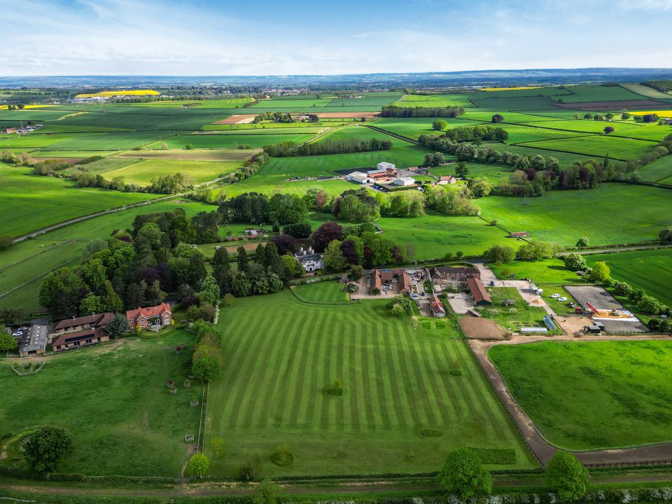 A landscape with fields and trees at Sykes Lodge in Malton
