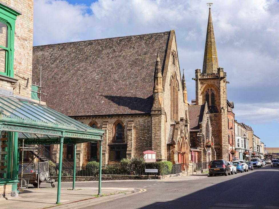 A street view with a church and buildings at Daffodil Lodge Saltburn-by-the-Sea