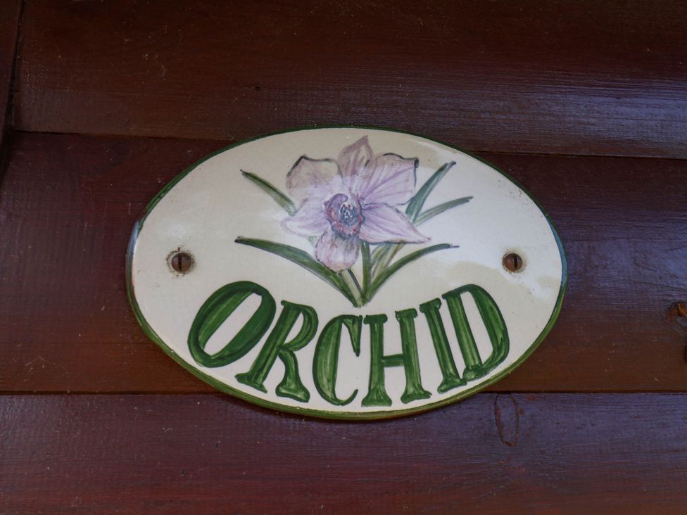 A sign with 'ORCHID' and a flower design at Orchid Lodge Saltburn-by-the-Sea