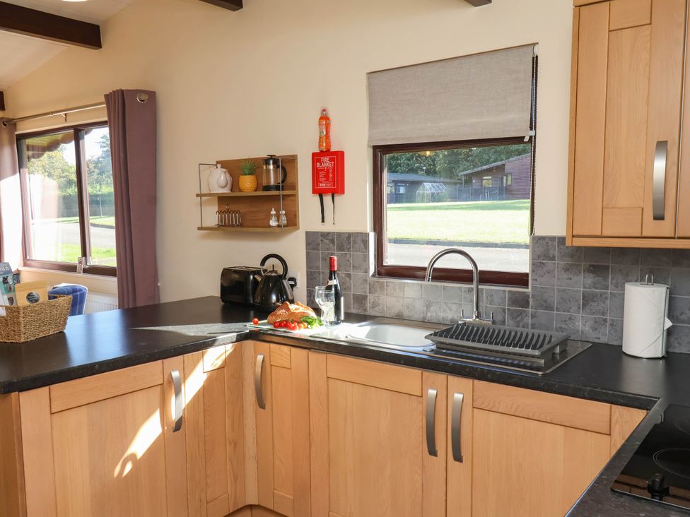 A kitchen with sink and window at Orchid Lodge Saltburn-by-the-Sea