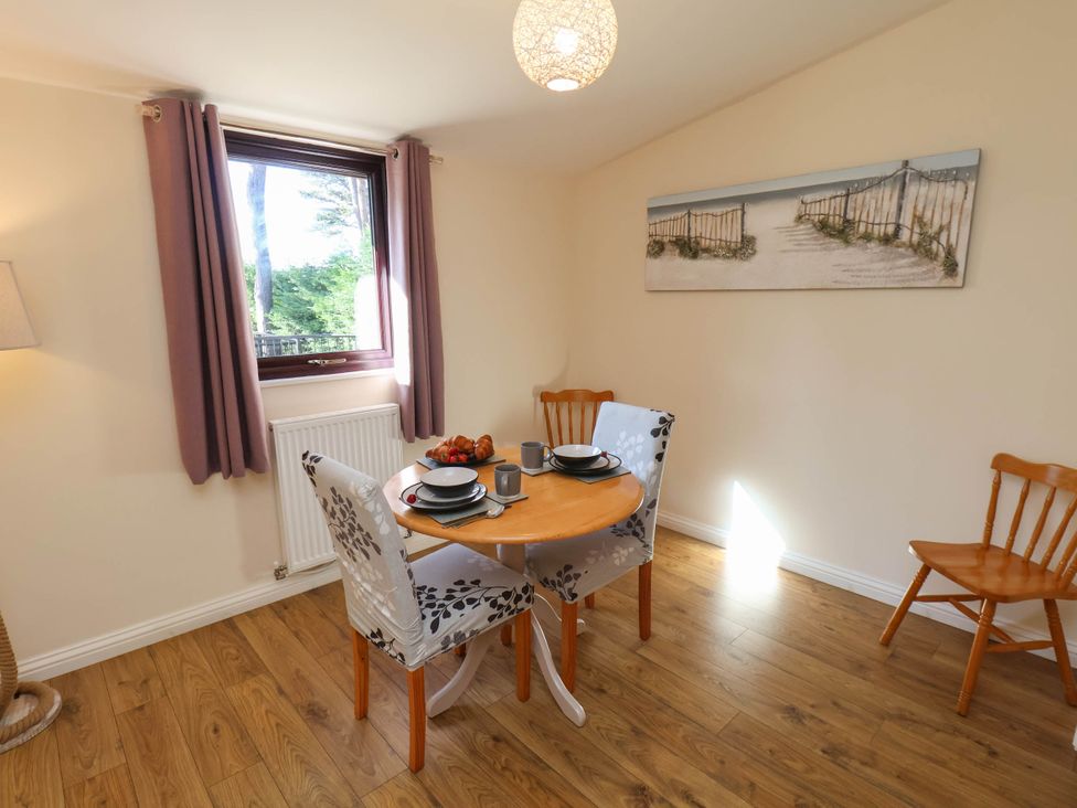 A dining room with a table and chairs at Orchid Lodge Saltburn-by-the-Sea