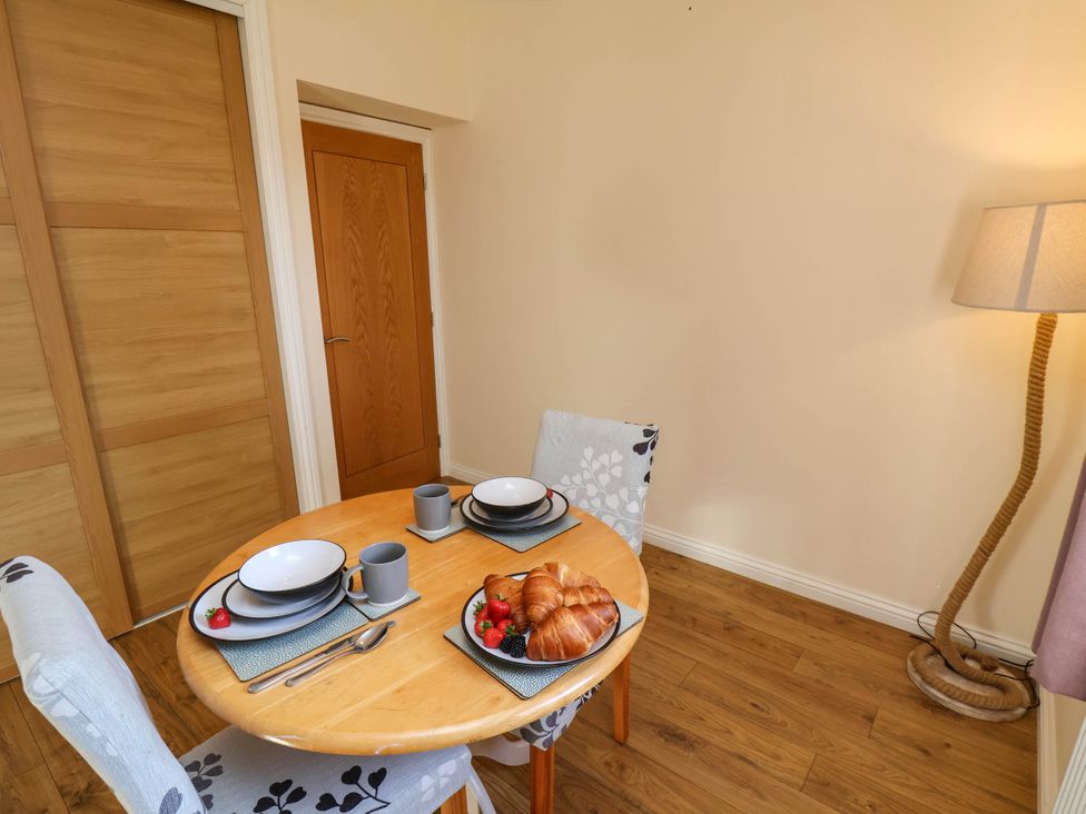 A dining room with a table set for breakfast at Orchid Lodge in Saltburn-by-the-Sea