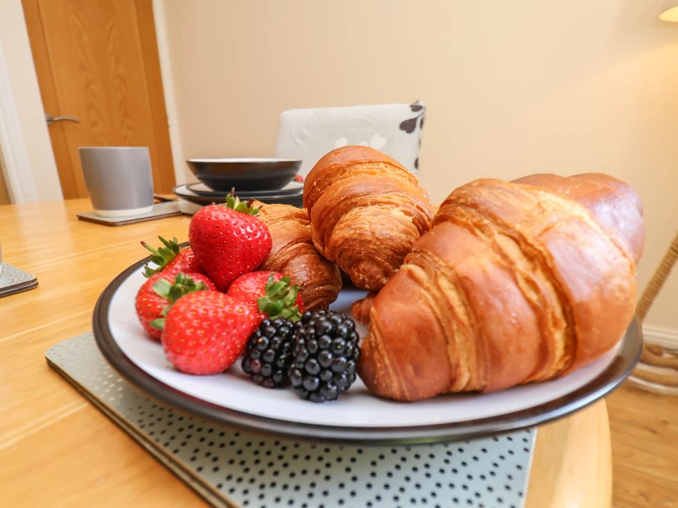 A plate with croissants and berries at Orchid Lodge in Saltburn-by-the-Sea