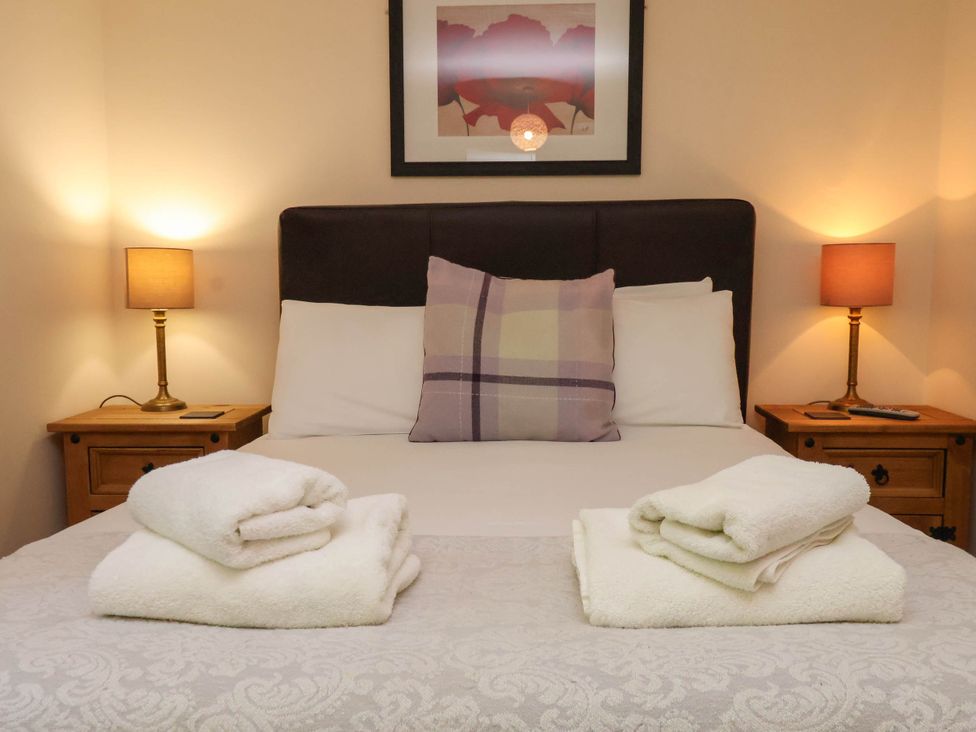 A bedroom with a bed and bedside tables at Orchid Lodge in Saltburn-by-the-Sea