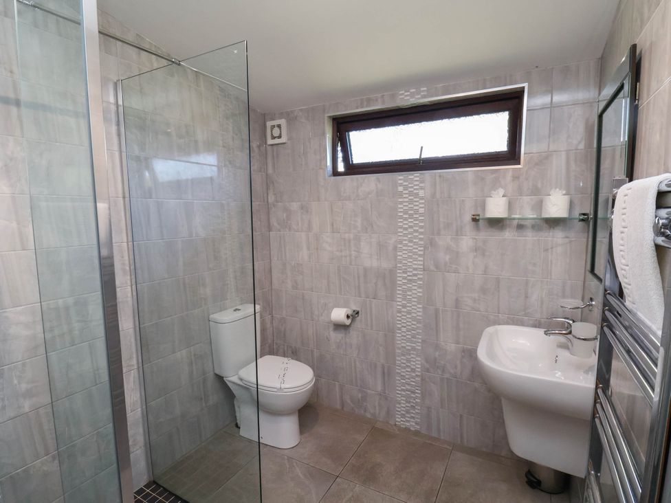 A bathroom with a shower, toilet, and sink at Orchid Lodge in Saltburn-by-the-Sea