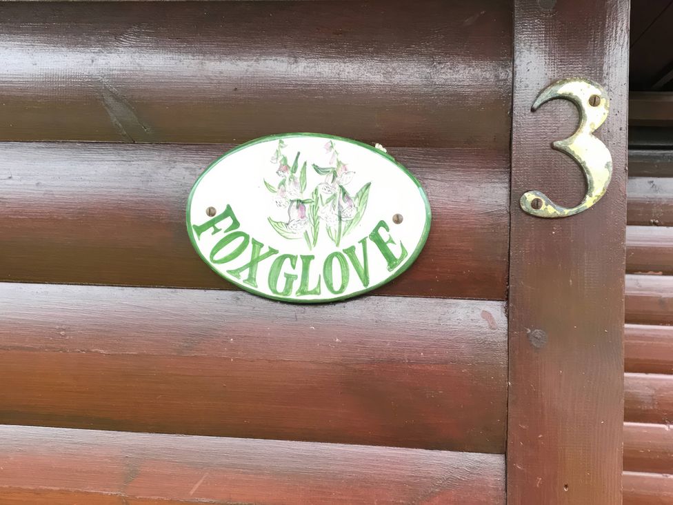 A sign displaying the name Foxglove attached to a wooden cabin at Foxglove Lodge Saltburn-By-The-Sea