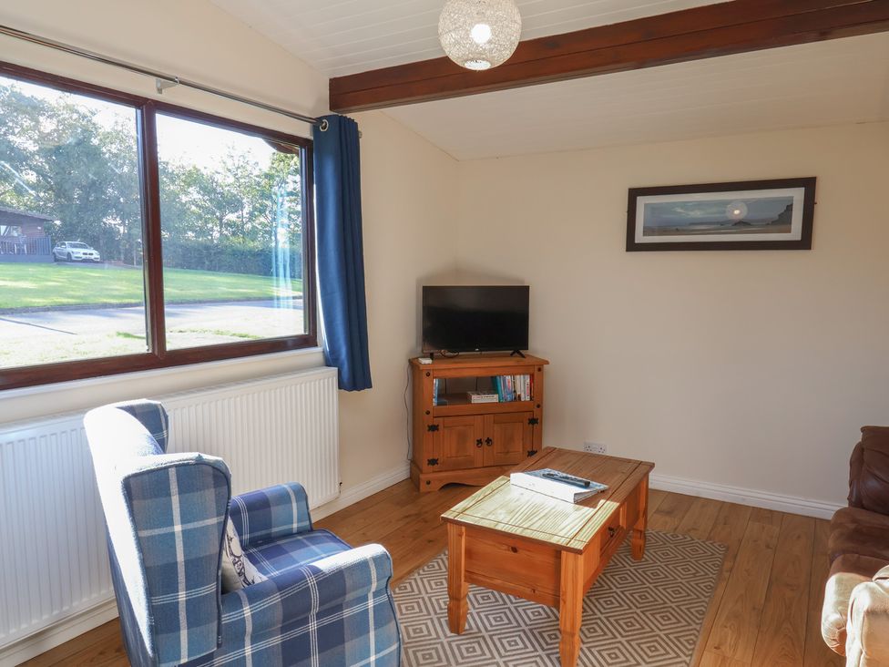 A living room with a television and sofa at Foxglove Lodge in Saltburn-By-The-Sea