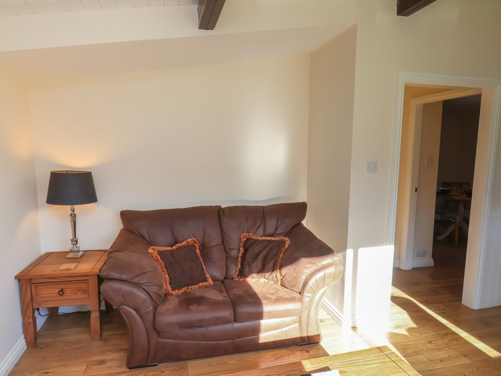 A living room with a sofa and lamp at Foxglove Lodge Saltburn-By-The-Sea