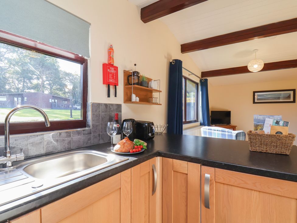 A kitchen with a sink and food on the counter at Foxglove Lodge in Saltburn-By-The-Sea