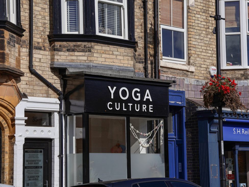 A shop front with a yoga studio sign at Foxglove Lodge in Saltburn-By-The-Sea