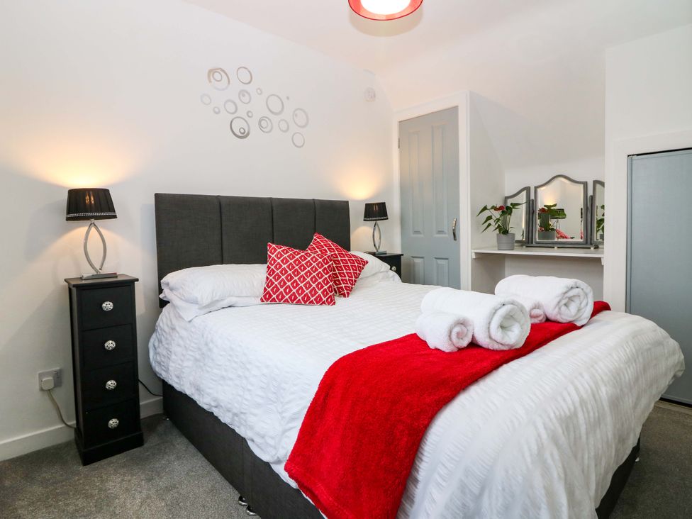 A bedroom with a bed and bedside table at Birds Nest in Jedburgh