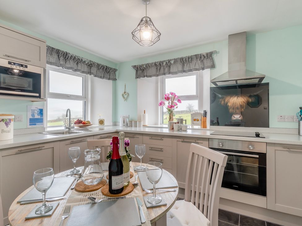 A kitchen with a table set for dining at Birds Nest in Jedburgh