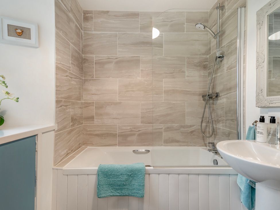 A bathroom with a bathtub and shower at Birds Nest in Jedburgh