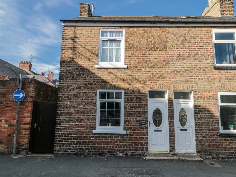 A brick house exterior with two doors and a window at Chapel Cottage in Filey