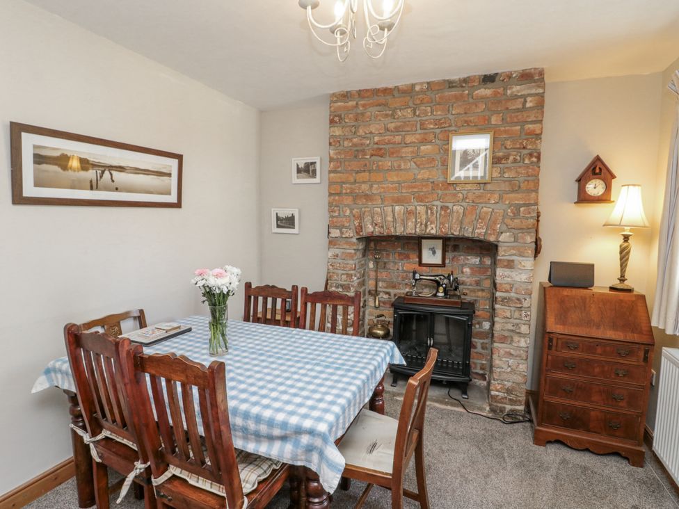 A dining room with a table and chairs at Chapel Cottage in Filey