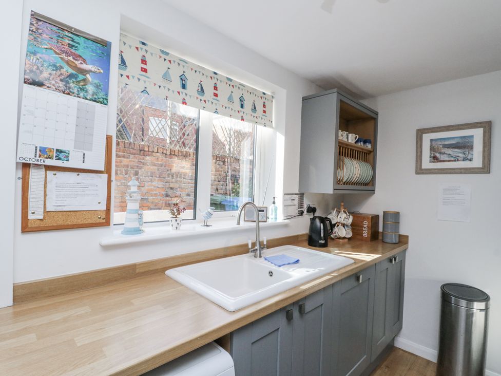 A kitchen with a sink and kettle at Chapel Cottage in Filey