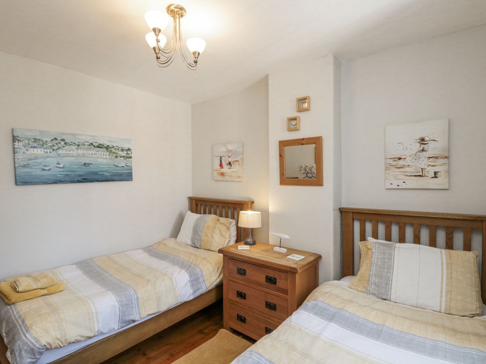 A bedroom with two single beds and a bedside table at Chapel Cottage in Filey