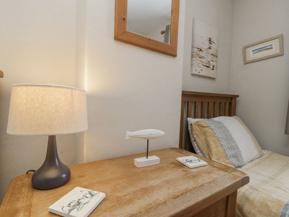 A bedroom with a bed and bedside table at Chapel Cottage in Filey