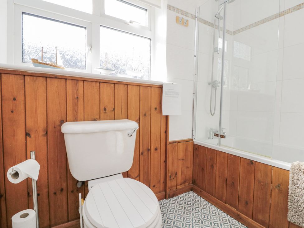 A bathroom with a shower and toilet at Chapel Cottage in Filey
