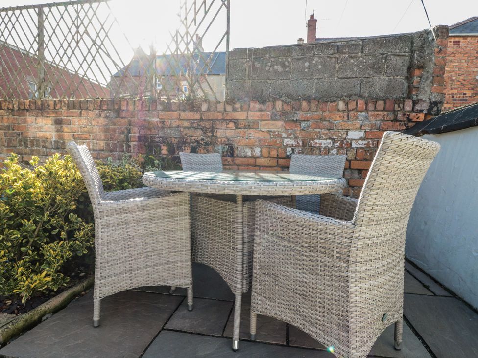 A garden space featuring a table and chairs at Chapel Cottage Filey