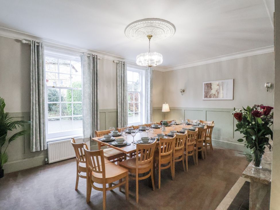 A dining room with a large table and chairs at The Manor House in Scarborough