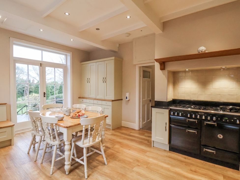 A kitchen with a table and chairs at The Manor House in Scarborough