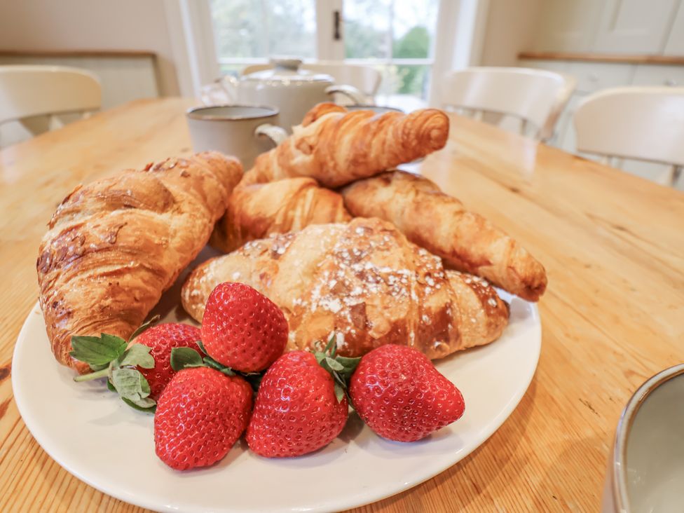 A plate of croissants and strawberries on a table at The Manor House in Scarborough