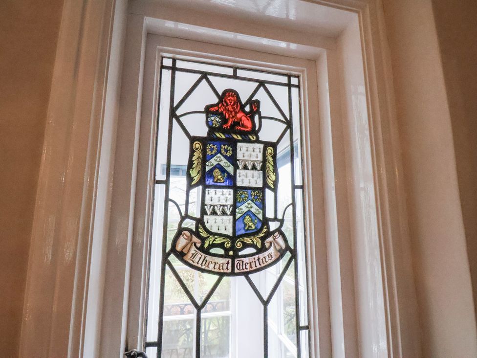 A stained glass window featuring a lion and a coat of arms at The Manor House in Scarborough