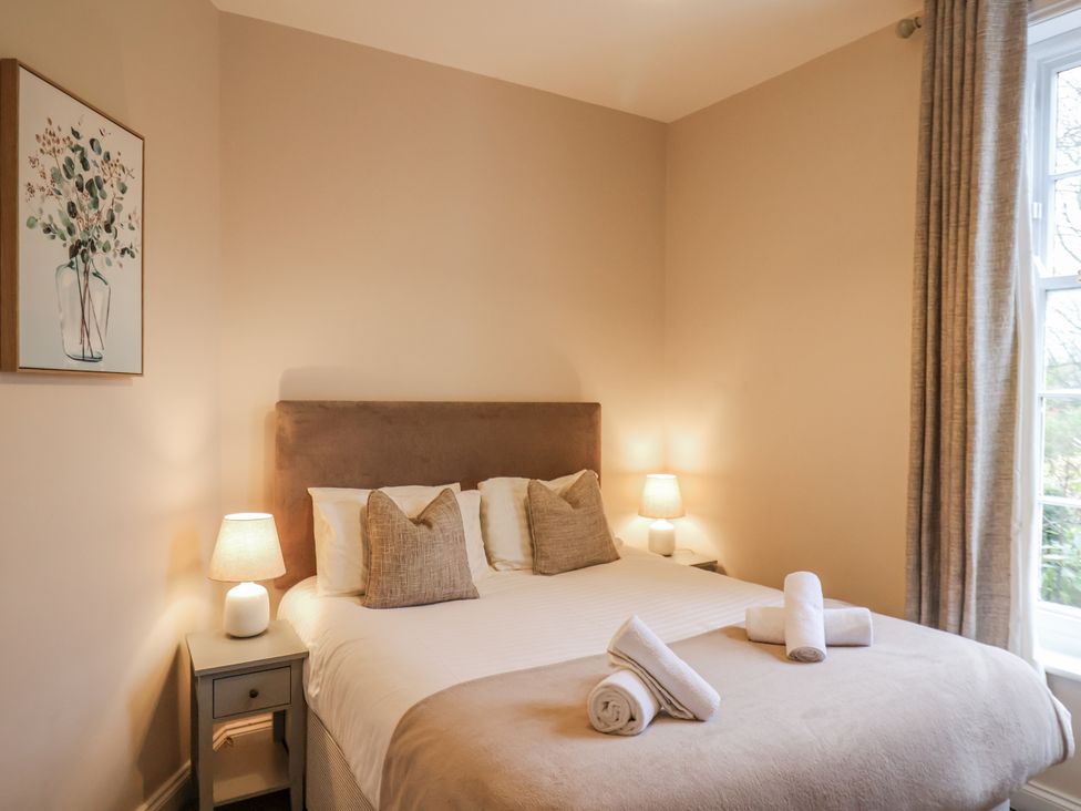 A bedroom with a bed and lamps at The Manor House in Scarborough