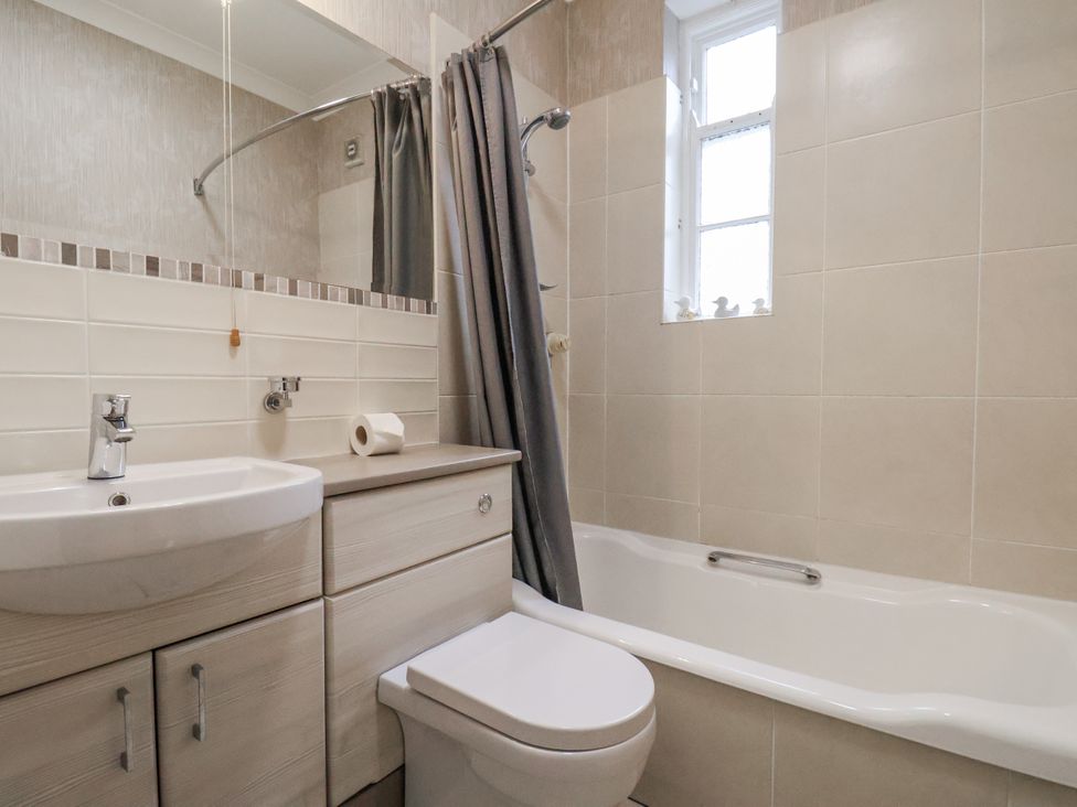 A bathroom with a sink and bathtub at The Manor House in Scarborough
