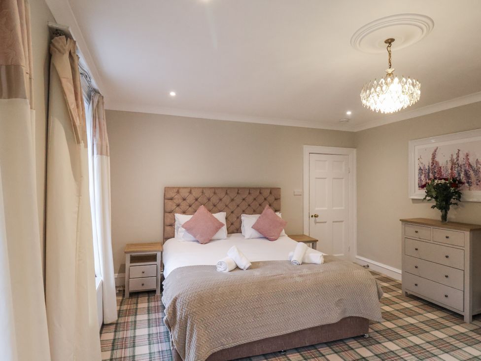 A bedroom with a bed and chest of drawers at The Manor House in Scarborough