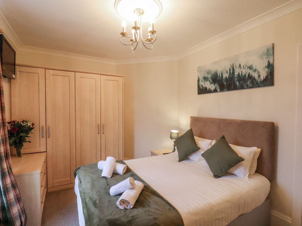 A bedroom with a bed and decorative items at The Manor House in Scarborough