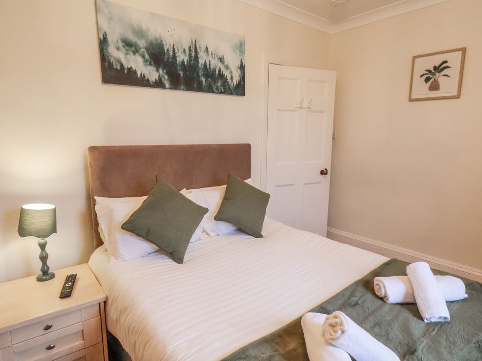 A bedroom with a bed and lamp at The Manor House Scarborough