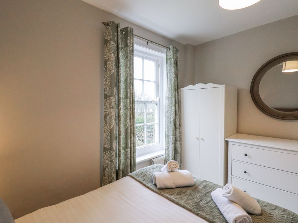 A bedroom with a bed and a window at The Manor House in Scarborough
