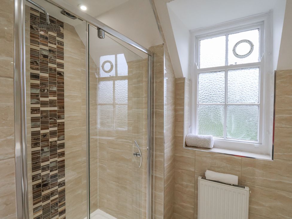 A bathroom with a shower and a window at The Manor House in Scarborough