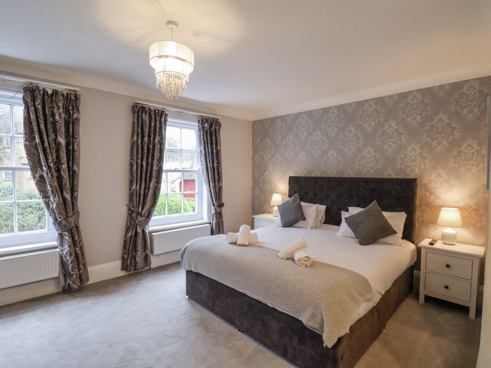 A bedroom with a bed and bedside tables at The Manor House Scarborough