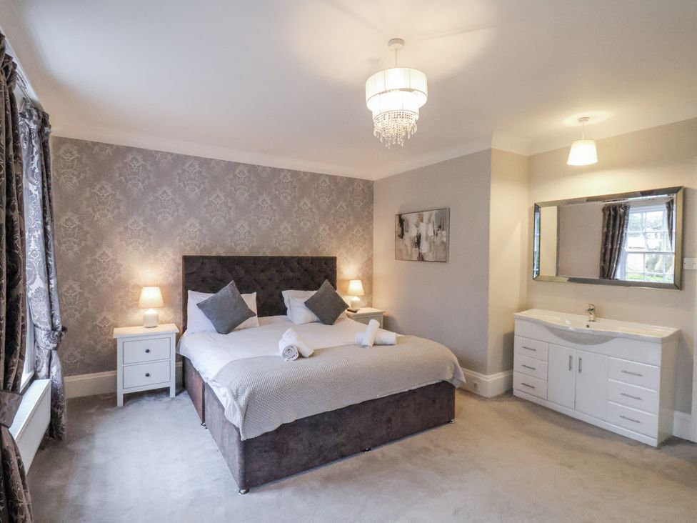 A bedroom with a bed and bedside tables at The Manor House in Scarborough