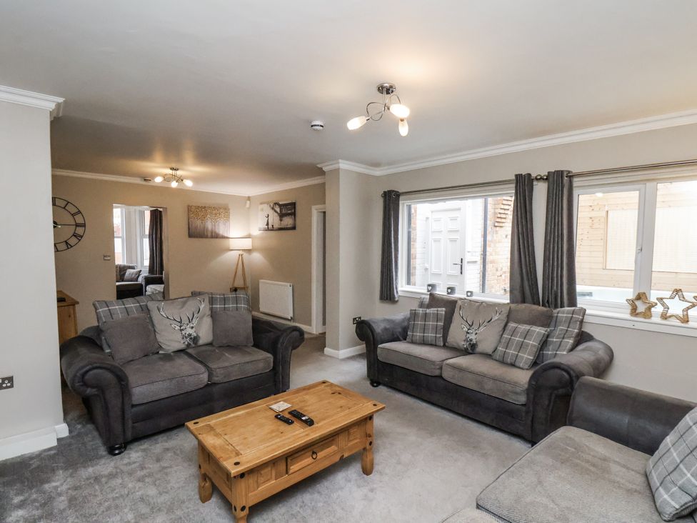 A living room with sofas and a coffee table at Tennyson House in Scarborough