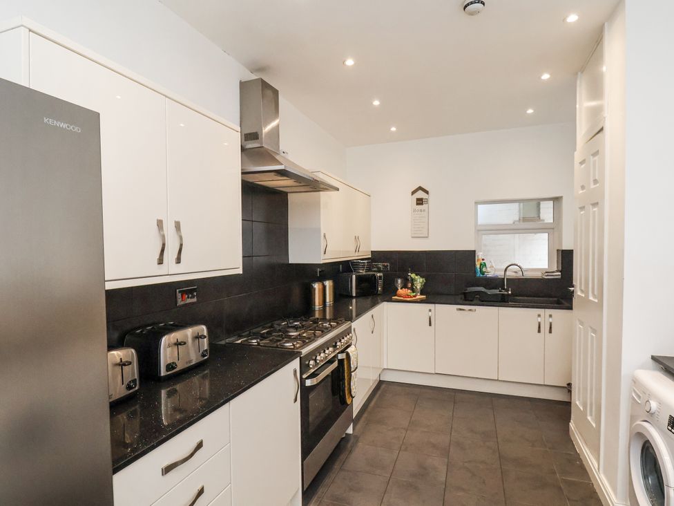A kitchen with appliances and cabinets at Tennyson House Scarborough