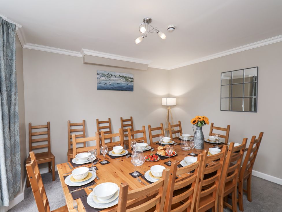 A dining room with a large table set for a meal at Tennyson House in Scarborough