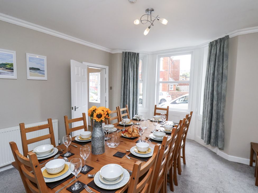A dining room with a table set for a meal at Tennyson House in Scarborough