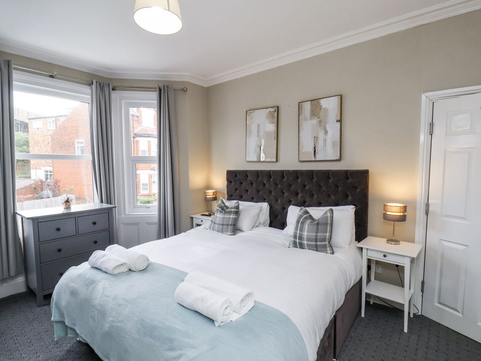 A bedroom with a bed and side tables at Tennyson House in Scarborough