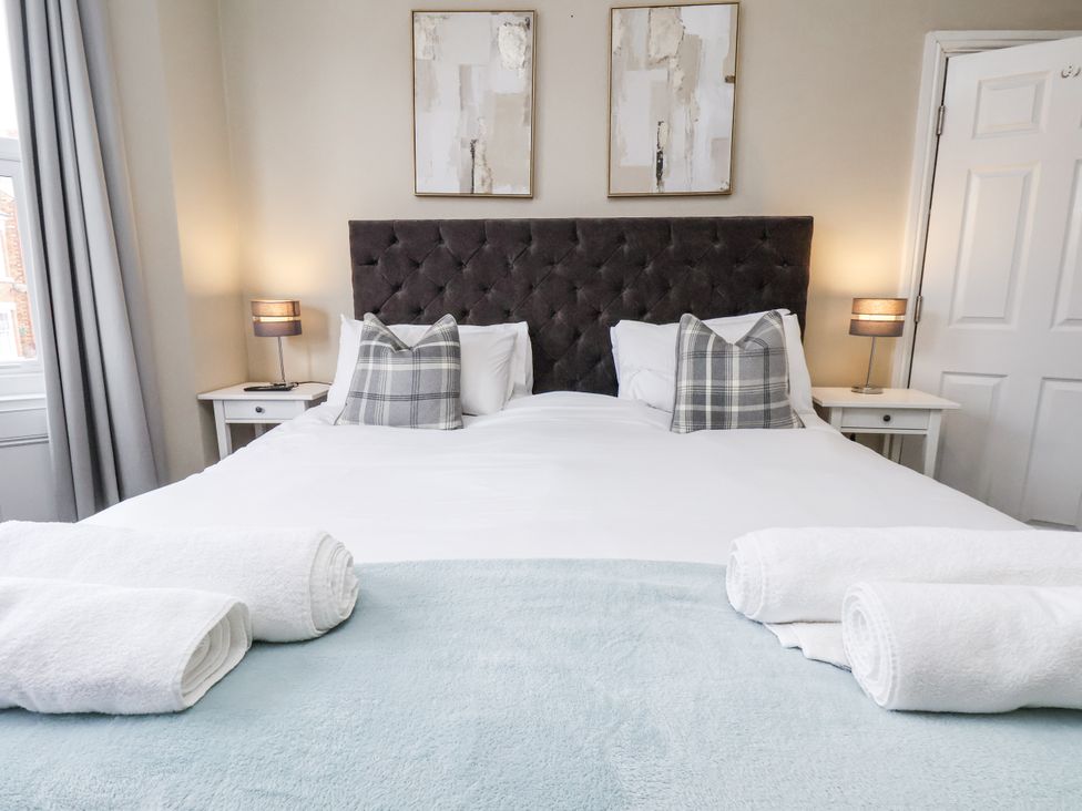 A bedroom with a bed and artwork at Tennyson House in Scarborough