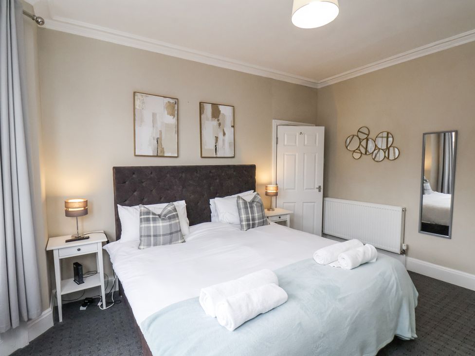 A bedroom with a double bed and bedside tables at Tennyson House in Scarborough